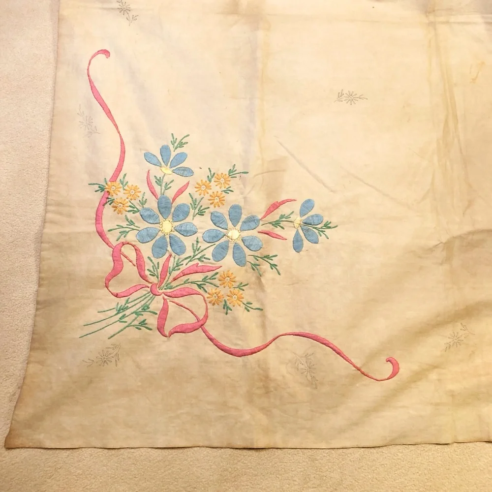 Vintage embroidery muslin, three corners begun, one ink outline blue pink red